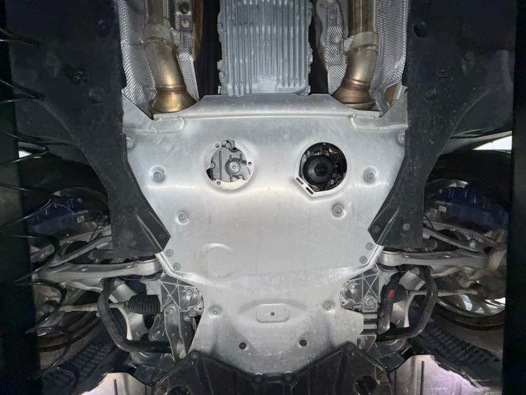 Accessible BMW M8 front underbody components checked during inspection